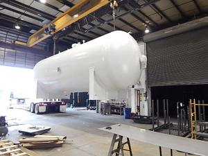 Tank about to depart in front of the metal preparation and coating facilities